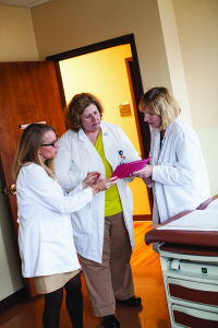 Nurses looking over a file at the Memory Clinic