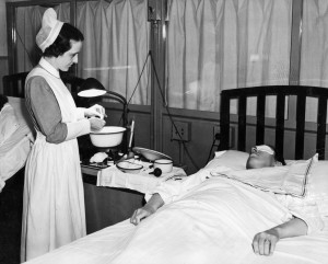 A nursing student applies hot compresses to the eyes of a patient at the Wilmer Ophthalmological Institute in a pre-1940 photo. Learning and practicing skills by the bedside on live patients had its limitations, not the least of which was a fear of soiling pristine white cuffs and apron, according to Our Shared Legacy: Nursing Education at Johns Hopkins 1889-2006. For more on how nursing education differs today.  Photograph courtesy of the Alan Mason Chesney Medical Archives