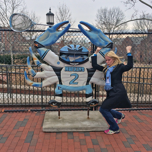 Stephanie Olmanni poses by a Johns Hopkins crab scultpure.